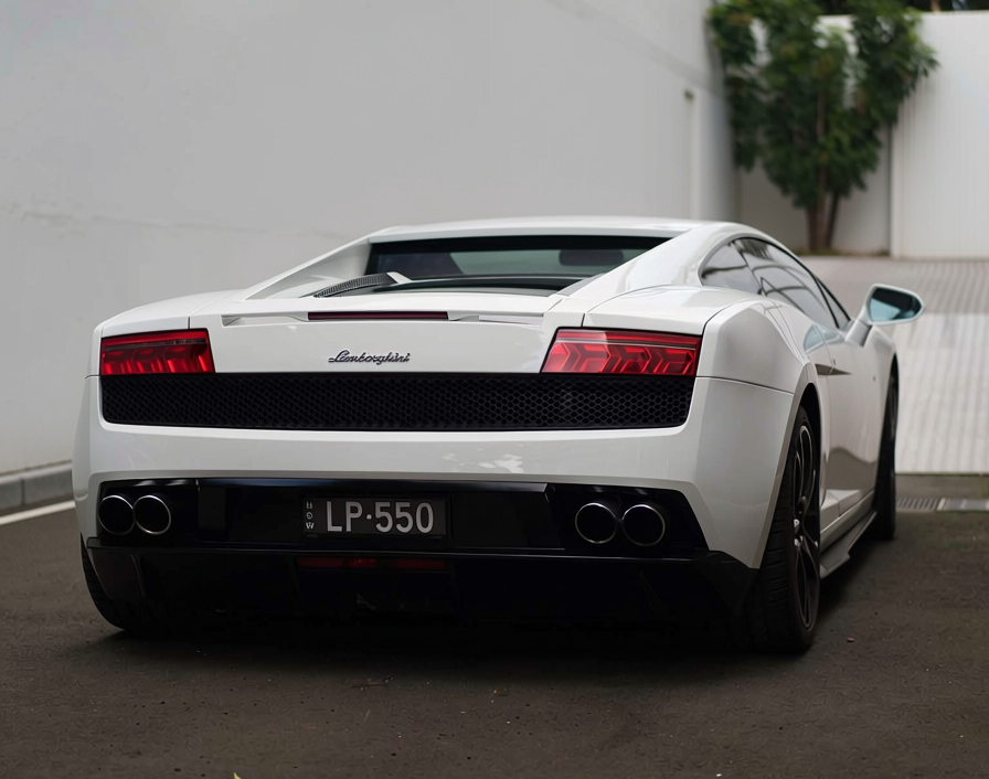 Rear view of a white Lamborghini Gallardo LP 550 exotic supercar available for Sydney wedding car hire.