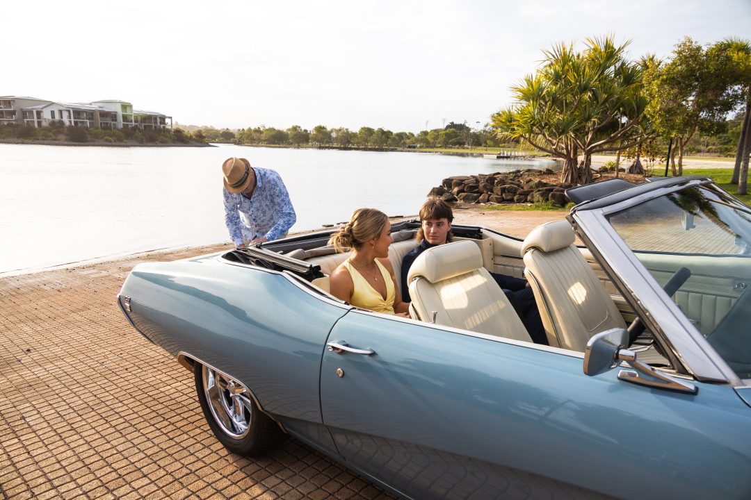 1969 Glacier Blue Buick GS400 Convertible parked along the Gold Coast shoreline with passengers during a pre-formal photoshoot