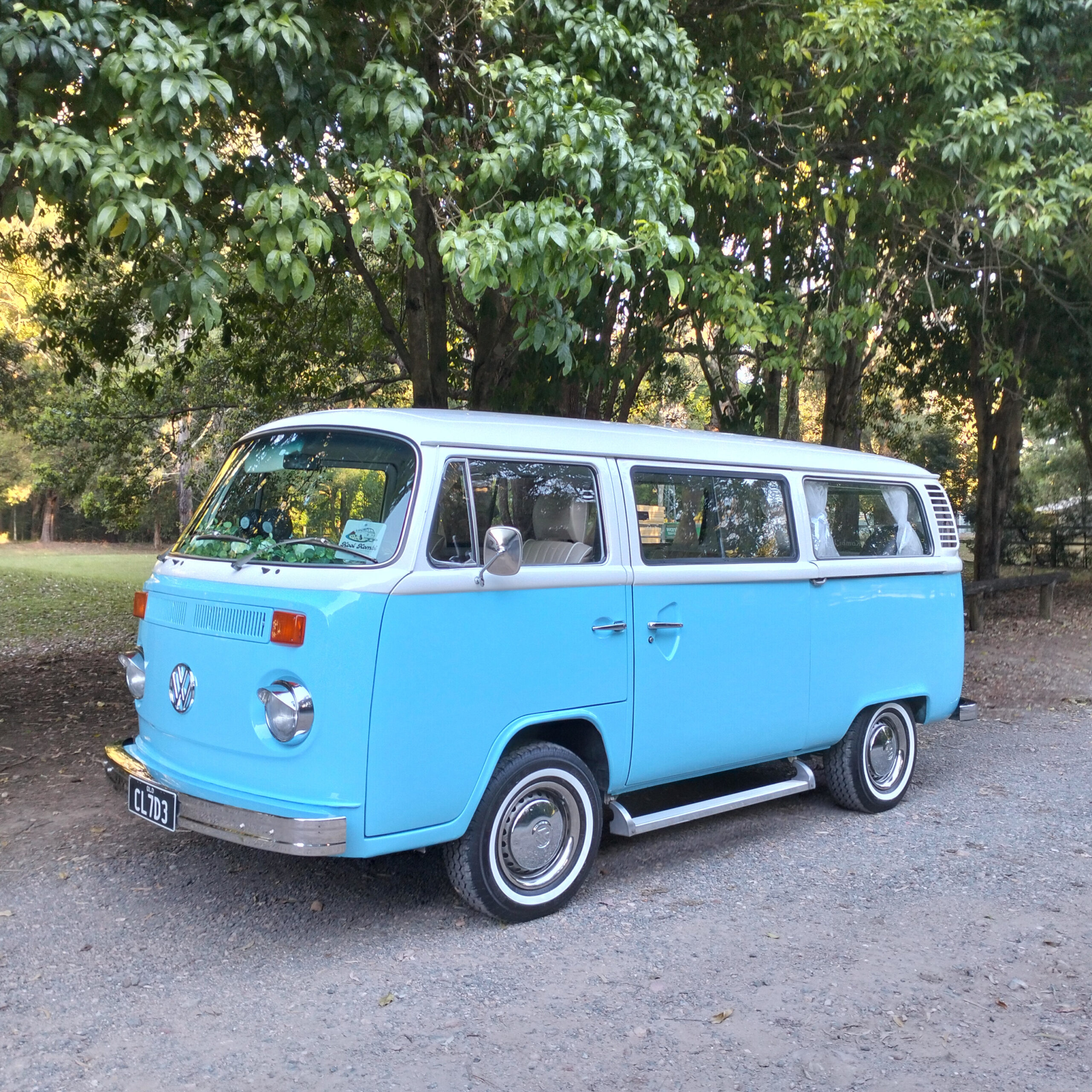 Blue and white air-conditioned 1977 VW Kombi Clyde parked for Gold Coast school formal group car hire